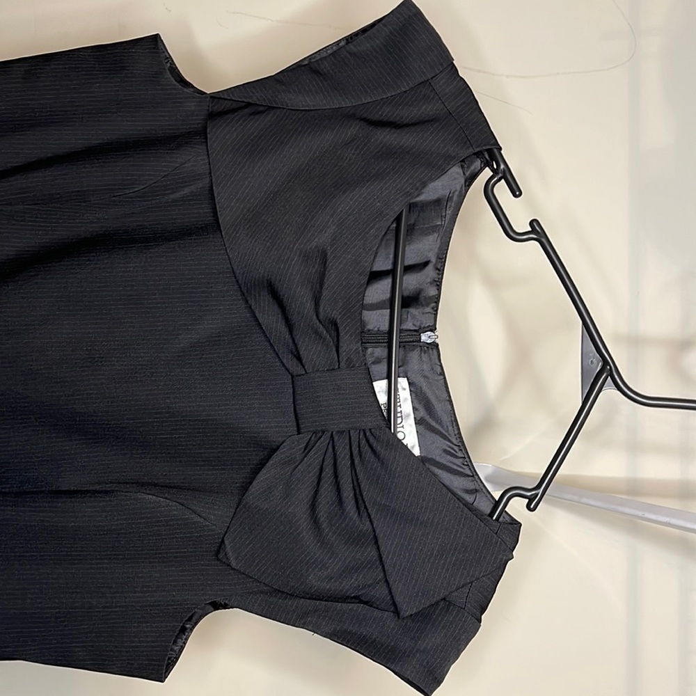 Black fitted dress with a bow at the top